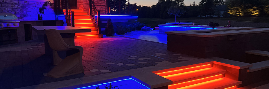 Modern backyard lit by blue and red RGB lights