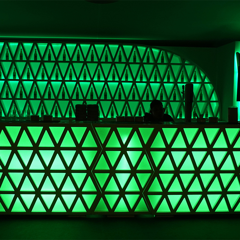 bar backlit by a green light wall