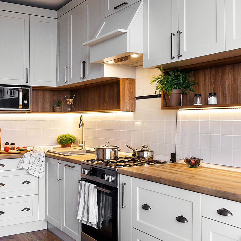 Traditional kitchen with pops of color and plants and under cabinet lighting