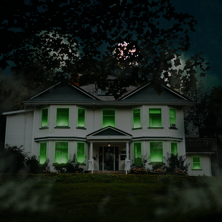 Halloween-themed house with eerie green lighting and a spooky atmosphere.