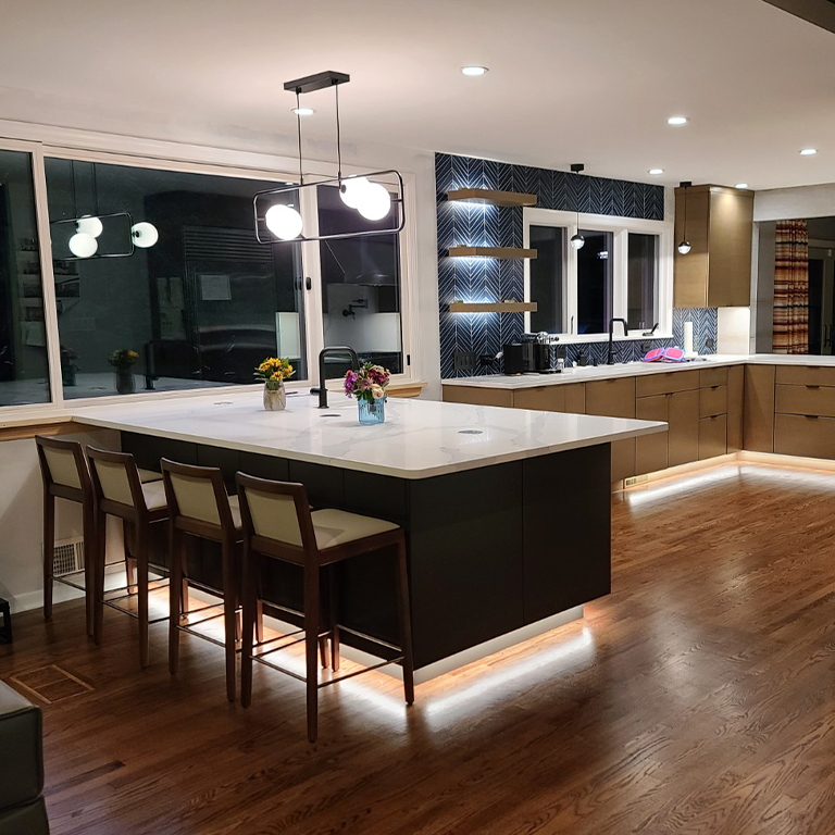 Kitchen with blue splashback and dining room with modern cool LED lighting