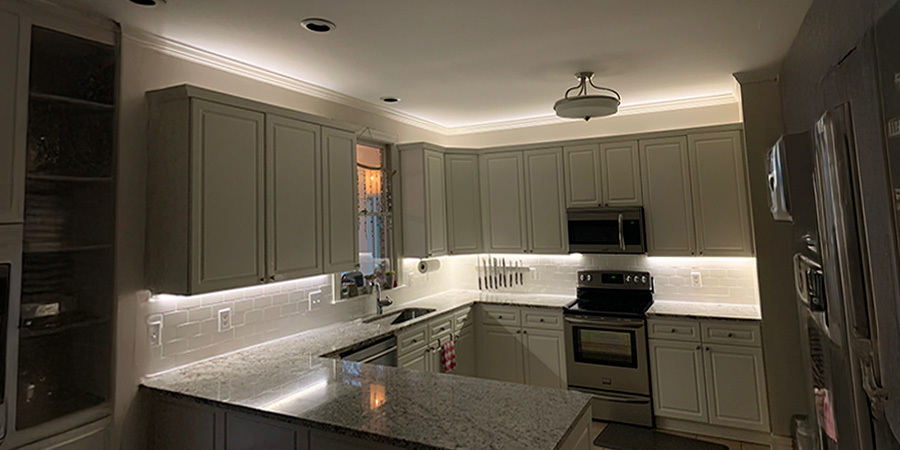 Suburban kitchen with strip lights under and above cabinets