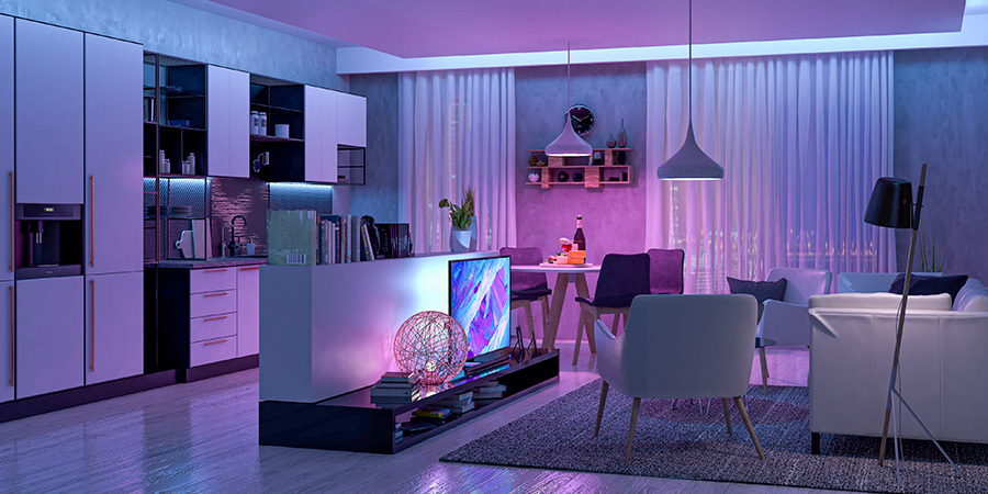 Modern living room with LED lights set on pink, purple and blue hues.