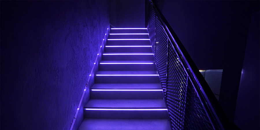 Purple LED-lit staircase providing a modern and vibrant ambiance