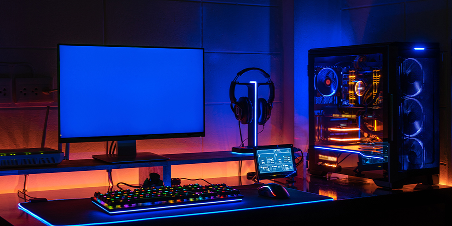 Set up gamer with blue and orange rgb strips lights.