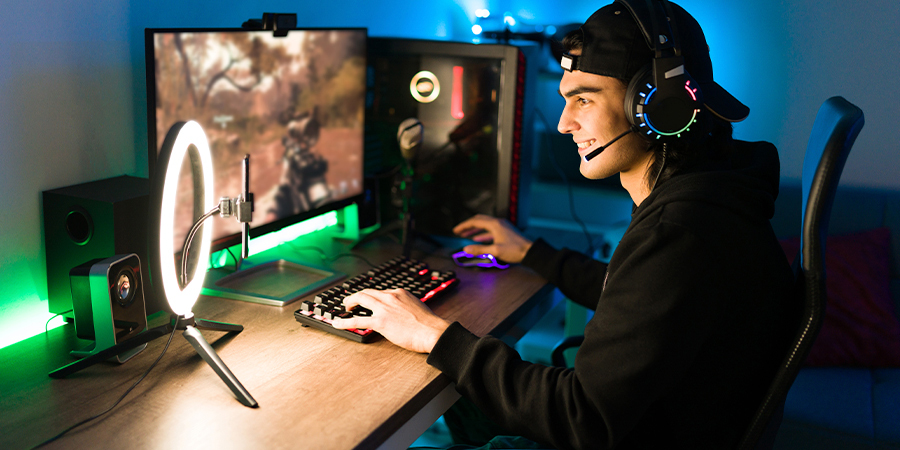 streamer playing on a gamer set up with green RGB lights.